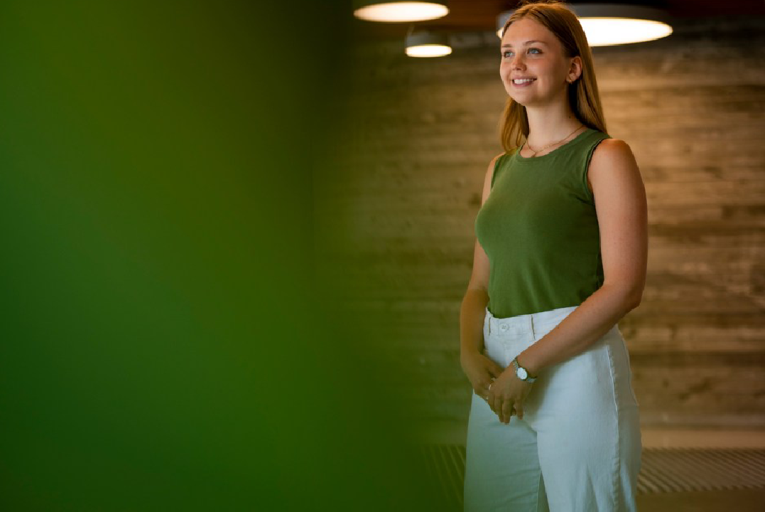 Smiling woman in green tank top.