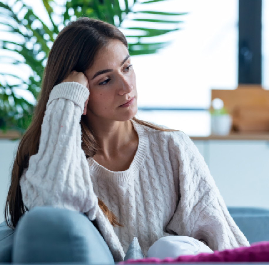 Woman in white sweater looking down.