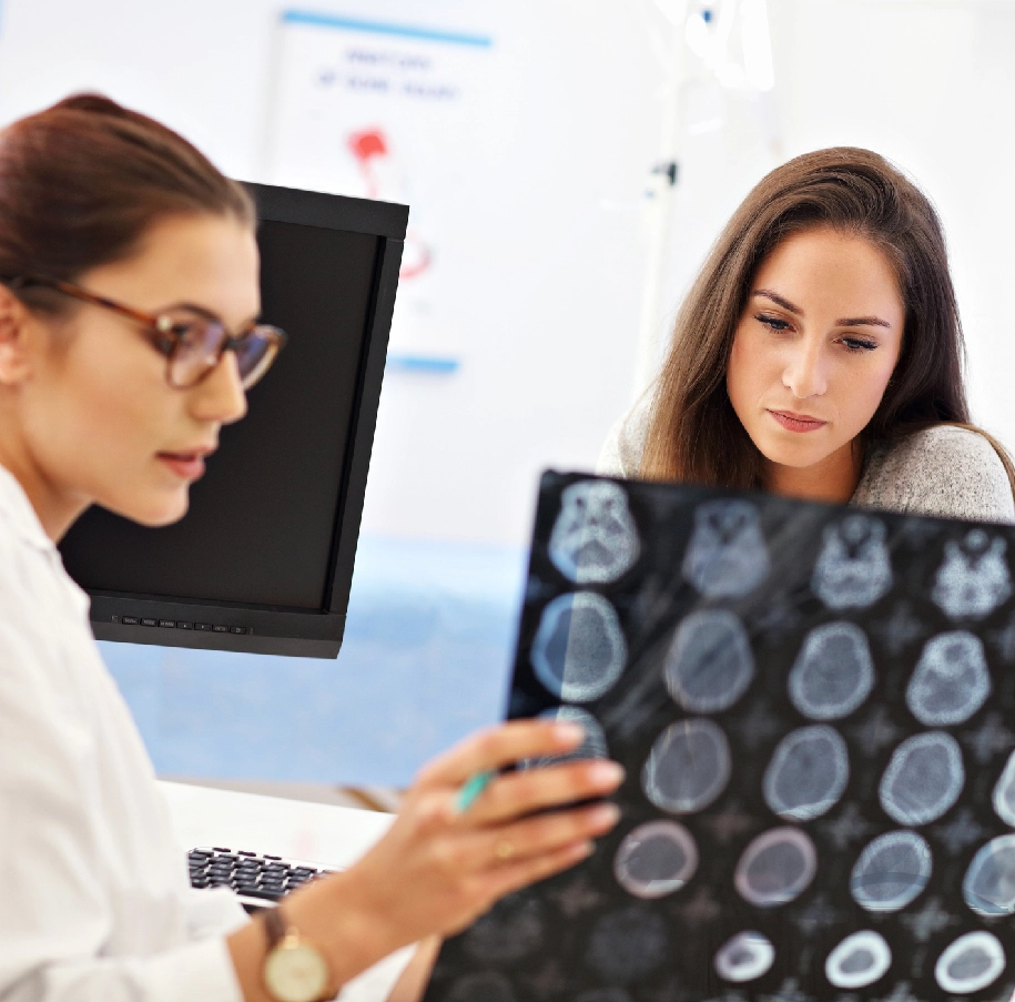 Doctor and patient reviewing brain scans.