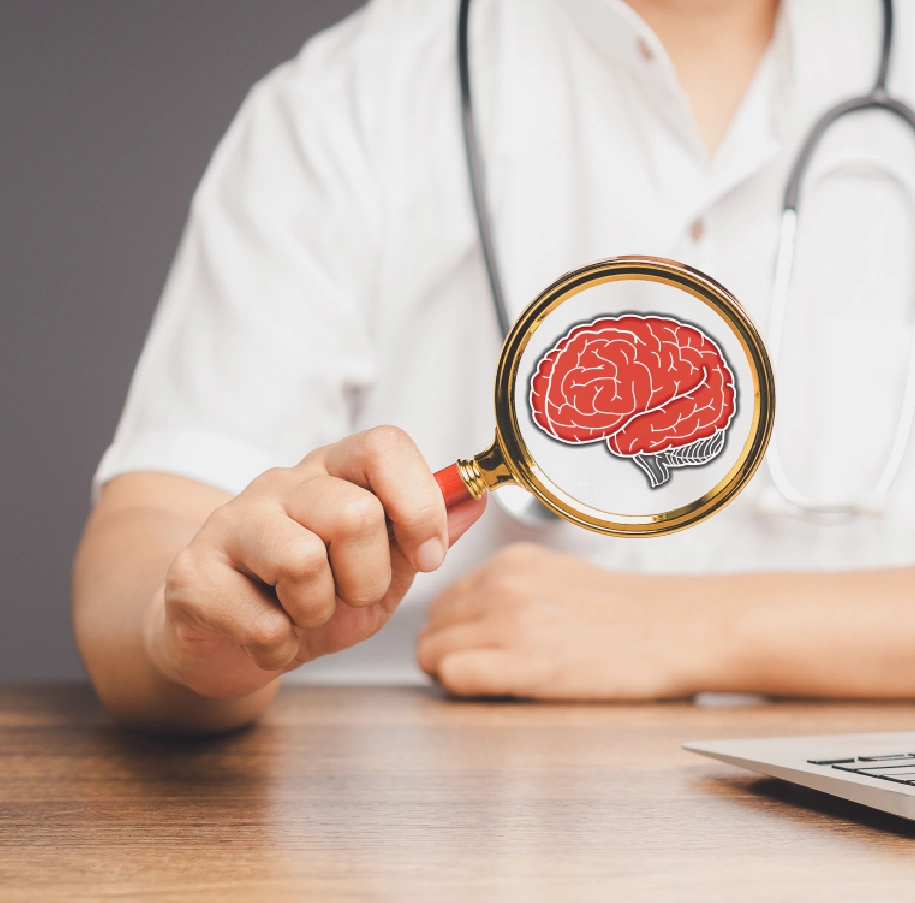 Doctor holding magnifying glass with brain inside.